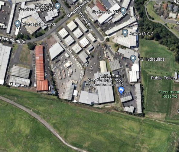 A screenshot of a map from Google Maps, showing industrial streets and a small grassy area.